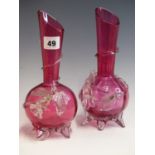 A PAIR OF EARLY 20TH CENTURY CRANBERRY GLASS VASES WITH SPIRAL AND FLOWER DECORATION.