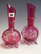 A PAIR OF EARLY 20TH CENTURY CRANBERRY GLASS VASES WITH SPIRAL AND FLOWER DECORATION.