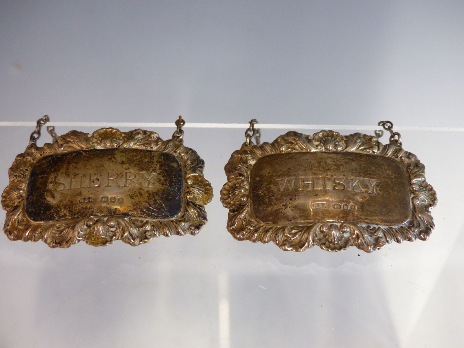 A PAIR OF HALLMARKED SILVER DECANTER LABELS FOR WHISKY AND SHERRY. LONDON HALLMARKS.