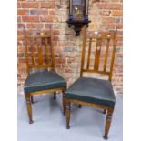 A PAIR OF EARLY 20th CENTURY ARTS AND CRAFTS STYLE OAK DINING CHAIRS WITH PIERCED HEART BACKS AND