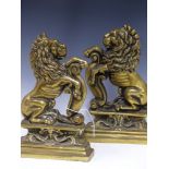 A PAIR OF ANTIQUE CAST BRASS RAMPANT LION FIRESIDE STANDS OR DOORSTOPS.