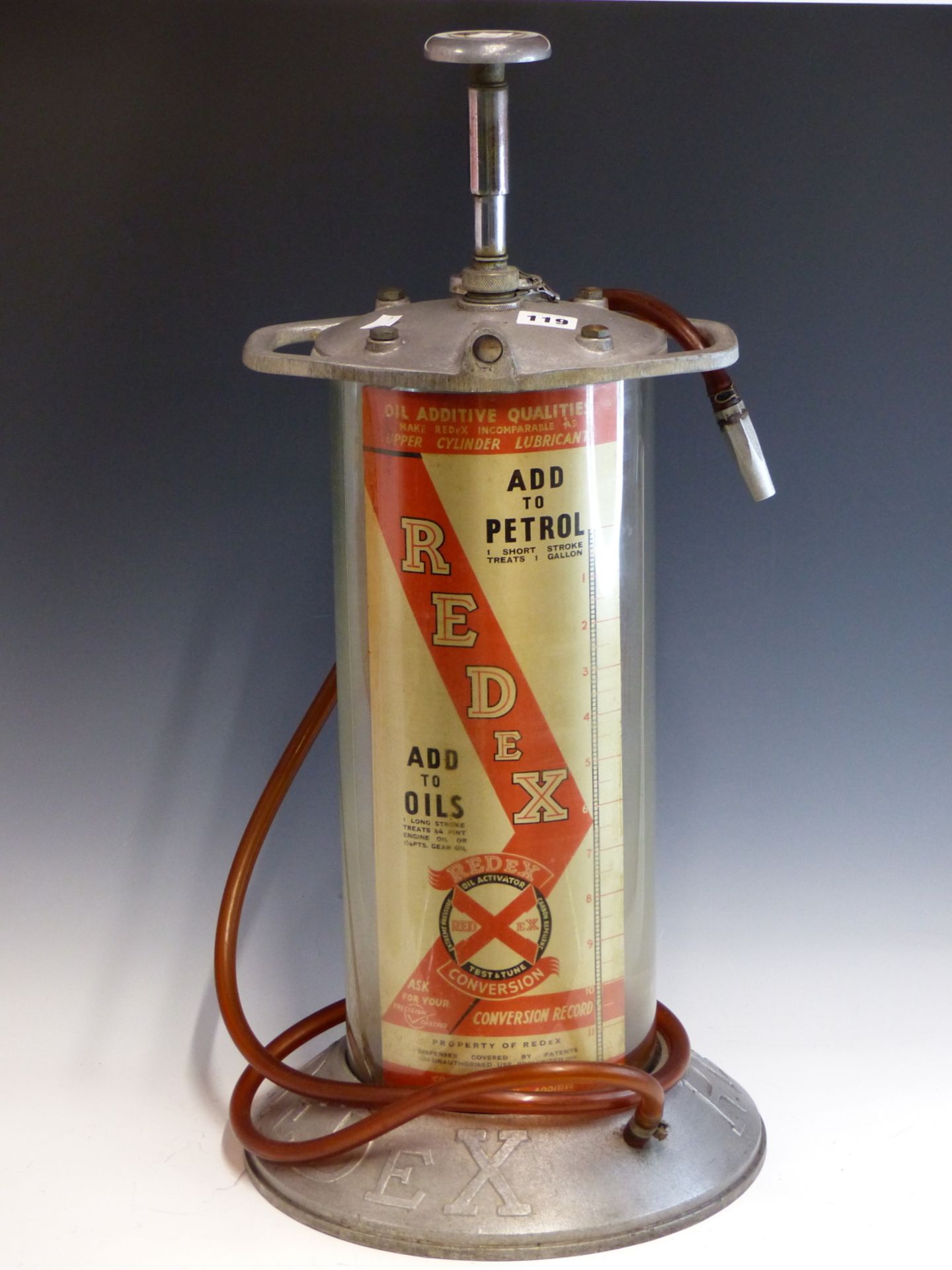 A VINTAGE REDEX OIL DISPENSER WITH ALLOY TOP AND BASE, RETAINING ITS TUBE AND NOZZLE.