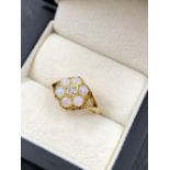 AN EARLY 20th CENTURY OLD CUT DIAMOND AND OPAL SEVEN STONE CLUSTER RING, THE SHANK STAMPED 18ct,