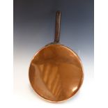 A LARGE VICTORIAN COPPER AND IRON HANDLED SHALLOW COOKING PAN.