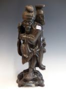 A LARGE VINTAGE CHINESE CARVED HARDWOOD FIGURE OF A FISHERMAN.