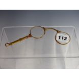 A FOLDING LORGNETTE WITH ENGRAVED GOLD PLATED FRAME.