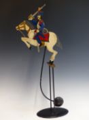 A VINTAGE ROCKING AUTOMATON CAVALRY CHARGER.