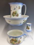 AN EARLY 20th CENTURY POTTERY WASH JUG AND BOWL SET WITH COTTAGE AND FLORAL DECORATION, AND TWO