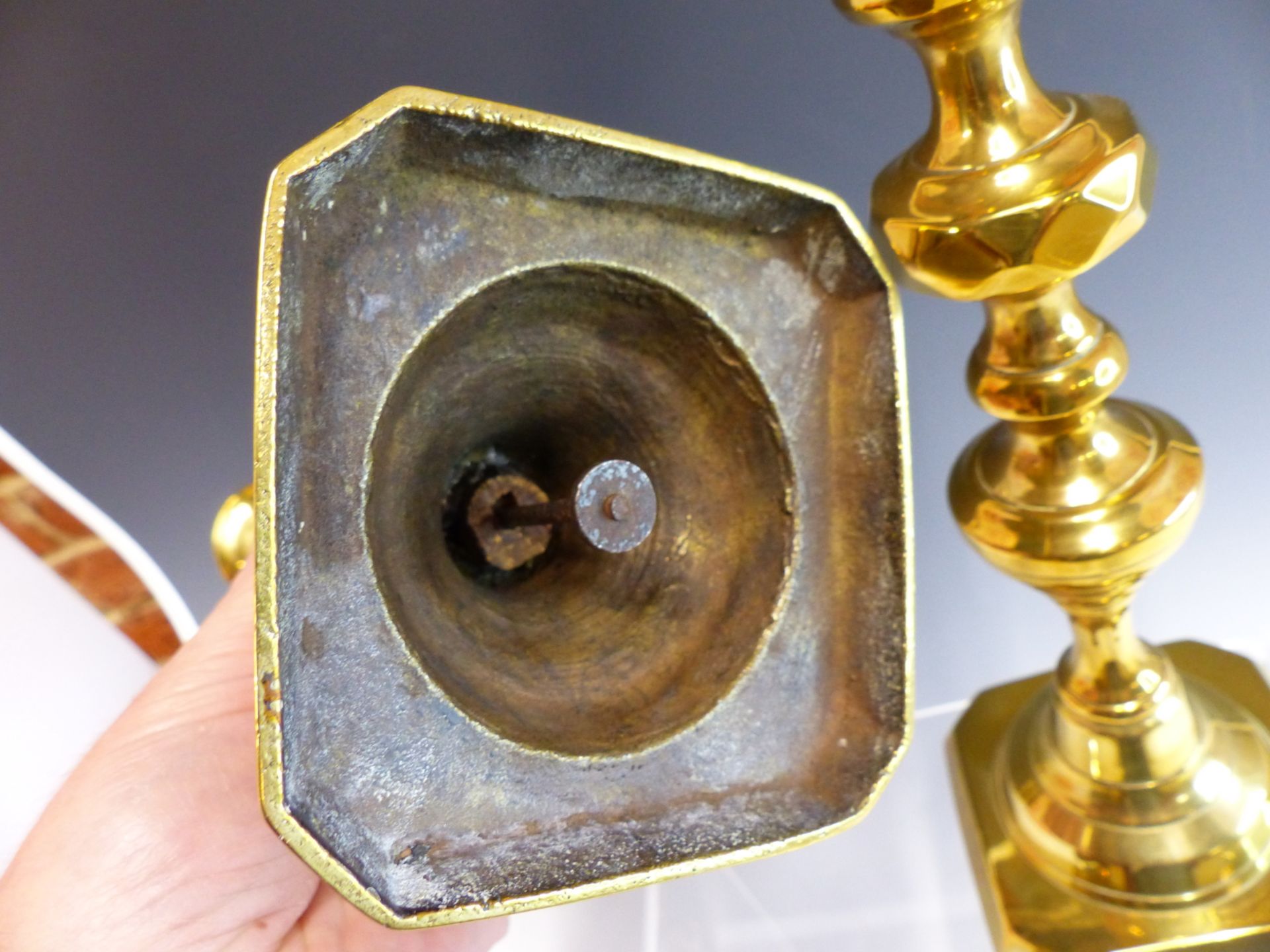 A PAIR OF LARGE VICTORIAN BRASS CANDLESTICKS WITH CENTRAL PUSHERS. - Image 2 of 2