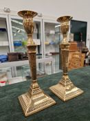 A PAIR OF ADAM PERIOD GEORGE III BELL METAL CANDLESTICKS, CIRCA 1780, ENGRAVED WITH LEAVES UP THE TA