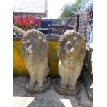 A PAIR OF COMPOSITE SEATED LIONS.