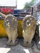 A PAIR OF COMPOSITE SEATED LIONS.