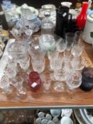AN AUBERGINE GLASS LEMONADE SET, OTHER DRINKING GLASS, A DECANTER, A RUBY OVERLAY GLASS BASKET,