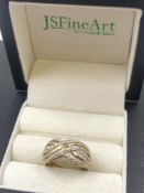 A 9ct HALLMARKED GOLD AND DIAMOND SIX ROW CROSSOVER RING. FINGER SIZE S. WEIGHT 4.10grms.