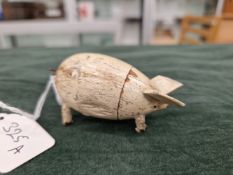 A VINTAGE HAND CRAFTED WOODEN PIG, OPENING COMPARTMENT WITH TWO MINIATURE PIGLETS INSIDE. BELIEVED