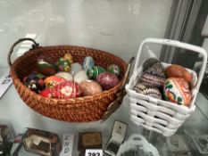 A COLLECTION OF DECORATED WOOD AND STONE EGG HAND COOLERS