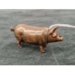 A VICTORIAN BRASS AND ENAMEL VESTA CASE IN THE FORM OF A PIG