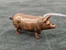 A VICTORIAN BRASS AND ENAMEL VESTA CASE IN THE FORM OF A PIG