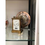 A CARRIAGE TIMEPIECE TOGETHER WITH A SMITHS MANTEL CLOCK WITH A CHROME AND PINK GLASS CHAPTER RING