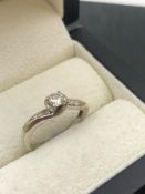 A SINGLE STONE DIAMOND TWIST RING WITH DIAMOND SET SHOULDERS. NO ASSAY MARKS, ASSESSED AS 9ct