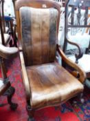 A VICTORIAN LEATHER UPHOLSTERED LOW ARM CHAIR