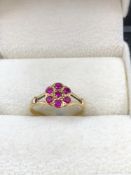A VINTAGE RUBY CLUSTER RING. UNHALLMARKED, ASSESSED AS 15ct GOLD. FINGER SIZE J. WEIGHT 1.49grms.