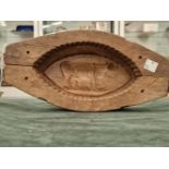 A EARLY 19th CENTURY LARGE FRENCH FARMHOUSE LARGE WOODEN BUTTER MOULD WITH A COW CARVING TO THE TOP.