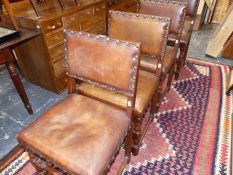 A SET OF FOUR LEATHER UPHOLSTERED DINING CHAIRS