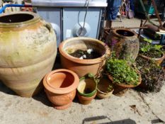 TWO TERRACOTTA OIL JARS AND VARIOUS GARDEN PLANTERS.