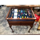 A GLAZED MAHOGANY TWO DRAWER DISPLAY TABLE