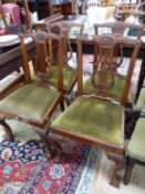 A SET OF FOUR EDWARDIAN LYRE BACK DINING CHAIRS