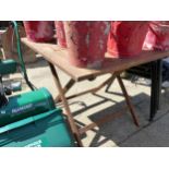 A SQUARE TEAK FOLDING GARDEN TABLE.