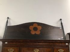 A MARY QUANT WOODEN DOUBLE BED HEAD INLAID WITH HER FLOWER HEAD LOGO