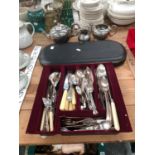 A TRAY OF ELECTROPLATE CUTLERY, A CASED CARVING SET TOGETHER WITH A THREE PIECE TEA SET.