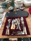 A TRAY OF ELECTROPLATE CUTLERY, A CASED CARVING SET TOGETHER WITH A THREE PIECE TEA SET.