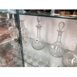 A PAIR OF DECANTERS, ANOTHER GLOBE AND SHAFT DECANTER TOGETHER WITH A CLARET JUG