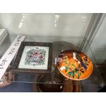 A FRENCH CIRCULAR BIRD AND FLOWER TILE TOGETHER WITH A FRAMED TILE OF 3 PINK FLOWERS