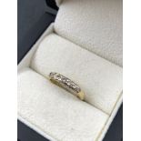 A 9ct HALLMARKED GOLD AND SEVEN STONE DIAMOND HALF ETERNITY RING, APPROXIMATE DIAMOND WEIGHT 0.