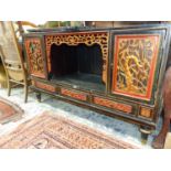 AN ORIENTAL CARVED AND LACQUERED SIDE CABINET.