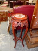 AN ORIENTAL HARDWOOD CARVED URN STAND.