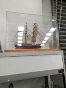 A MODEL TWO MASTED YACHT IN FULL SAIL