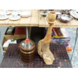 AN INDIAN PAINTED HARDWOOD JAR AND COVER AND A WEATHERED WOOD CANDLE STAND.