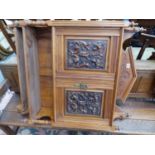 AN EDWARDIAN CARVED WALL CABINET