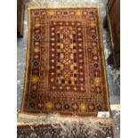 A TRIBAL BELOUCH RUG 136 x 92 cm, TOGETHER WITH AN ORIENTAL RUG OF PERSIAN DESIGN (2)