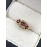 AN ANTIQUE RUBY AND OLD CUT DIAMOND CLUSTER TYPE RING. NO ASSAY MARKS, ASSESSED VARIOUSLY BETWEEN