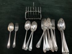 A QUANTITY OF HALLMARKED SILVER CUTLERY AND A SILVER TOAST RACK. GROSS WEIGHT 1268grms.