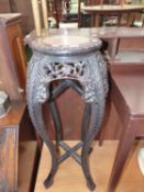 AN ANTIQUE ORIENTAL CARVED URN STAND