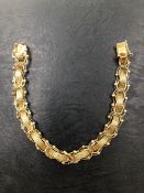 AN UNUSUAL LINK AND WOVEN BRACELET. THE BRACELET WITH NO ASSAY MARKS, STAPED A AMERICAN 14KT,