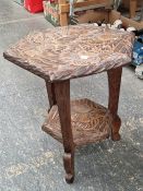 AN ARTS AND CRAFTS SIDE TABLE CARVED WITH FLORAL DESIGN IN THE MANNER OF LIBERTY AND CO.. THIS DESIG