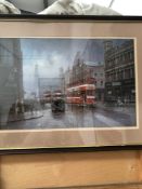 A FRAMED PRINT OF TRAMS IN A CITY DON BRECKON. 40 x 60cms